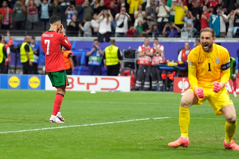 Cristiano Ronaldo reacts after missing a penalty kick